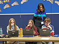  Students work at a desk on a project